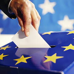 Close-up of a hand dropping a ballot into a European Union-themed ballot box