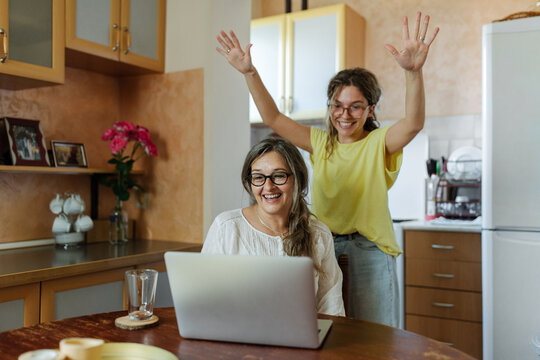 Mother and daughter having a video call together using laptop