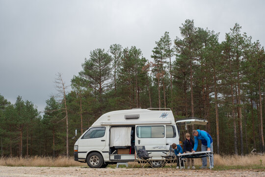 Father establish camp with his sons