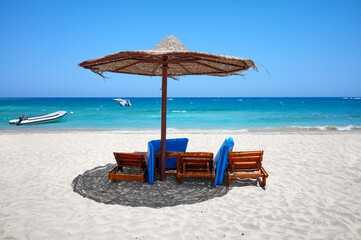 Tropical sandy beach on a sunny day, summer vacation concept.