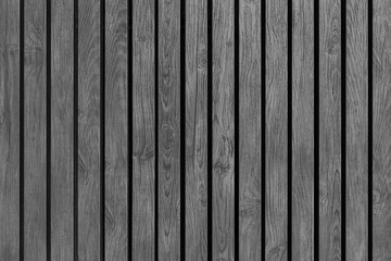 Black and white photo background texture of a wall made of wooden slats. Seamless pattern of modern...