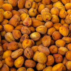 Orange dried apricots. Dried apricot, dried fruits are scattered on the table.