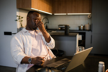 The man was tired working on a laptop