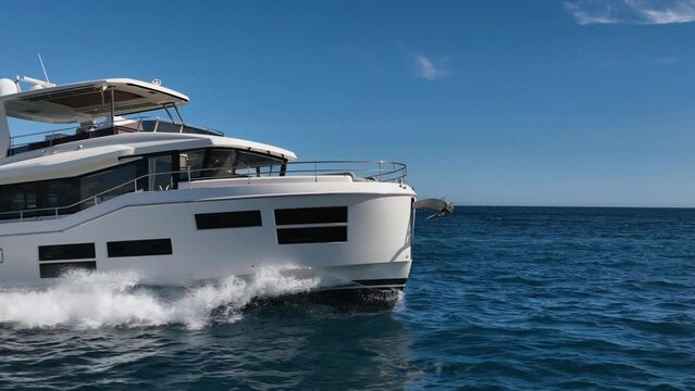 Close up drone shot of bow of luxury yacht driving at sea in slow motion