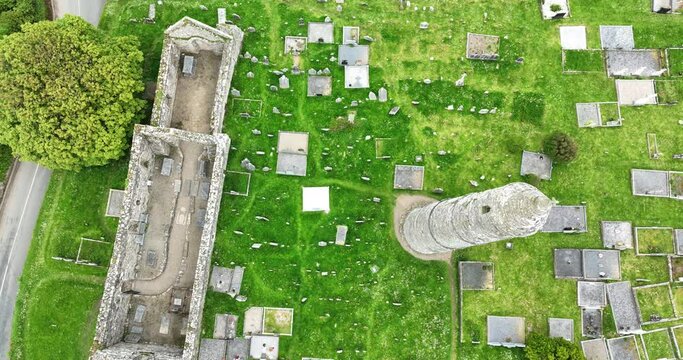 Ireland Epic locations drone looking down on Ardmore Round Tower and cathedral, monastic site of saint Declan in Waterford on a bright summer day