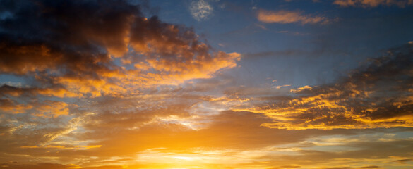 Dramatic Colorful Sunset Sky. Clouds with Sunrays. Cloudscape Sunset Background. Panorama Sky....