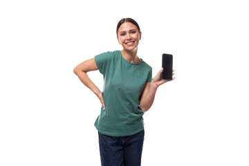 young black-haired woman dressed in a basic t-shirt holding a smartphone