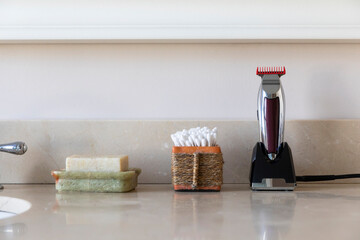 Vertical image Electric shaver still life in bathroom with q tips