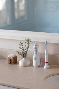 Electric Toothbrush next  sink  still life water flosser still life