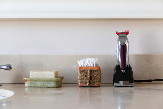 Vertical image Electric shaver still life in bathroom with q tips