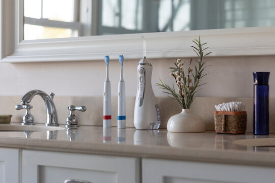 Electric Toothbrush next to sink  still life water flosser still life