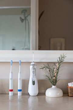 Bathroom Electric Toothbrush next to sink  still life water flosser 