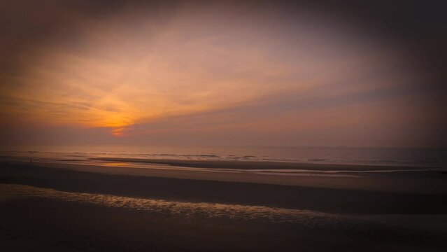Aerial view of sunset, sandy beaches and ocean in Blankenberge, Flanders region, Belgium.
