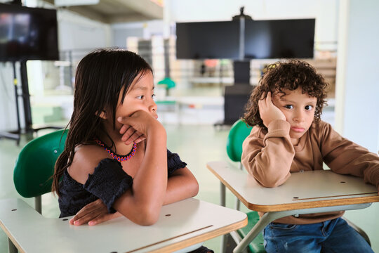 Two bored children in the classroom