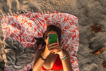 Woman using Smartphone at the Beach