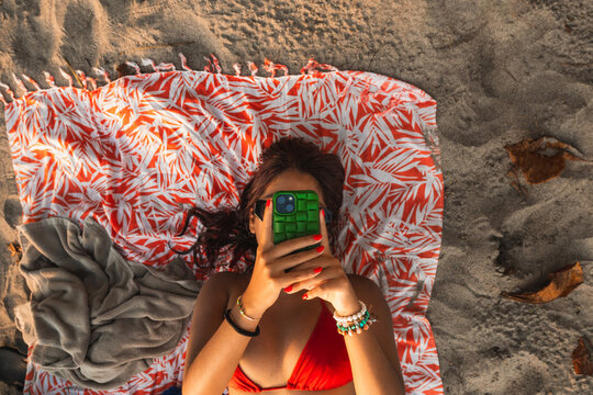 Woman using Smartphone at the Beach