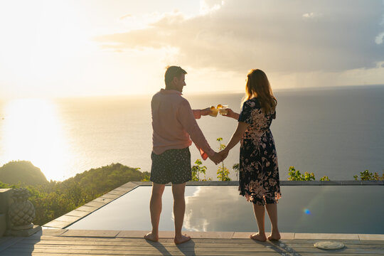 Couple With Cocktails and Ocean View from Caribbean Villa