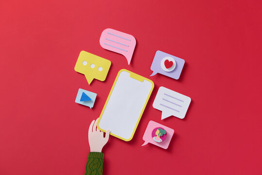 Smartphone and social media app, like button and speech bubbles on red