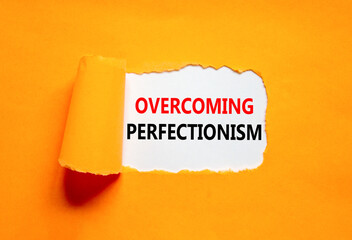Overcoming perfectionism symbol. Concept words Overcoming perfectionism on beautiful white paper. Beautiful orange paper background. Business Overcoming perfectionism concept. Copy space.
