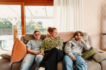 One parent family sitting together on a living room couch
