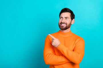 Photo of smiling attractive nice man wear trendy clothes look empty space isolated on cyan color...