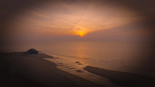 Aerial view of sunset, sandy beaches and ocean in Blankenberge, Flanders region, Belgium.