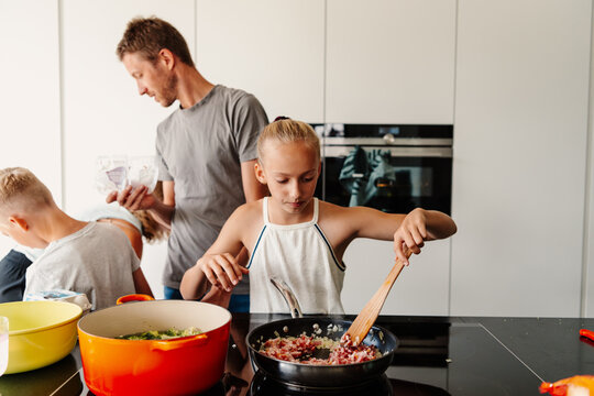 Family cooking together in modern kitchen