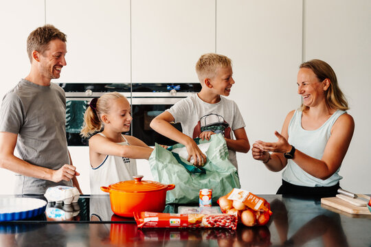 Fun family using reusable groceries shopping bag