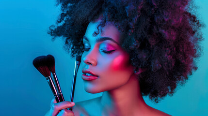 A stunning beauty portrait of a woman with luscious curly hair holding makeup brushes near her face