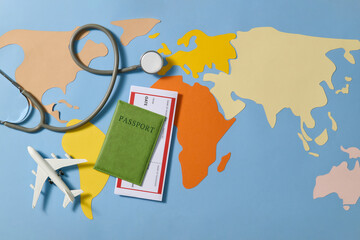 Airplane, passport and ticket with stethoscope on world map background