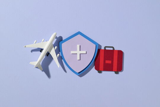 Suitcase and airplane with inscription travel insurance