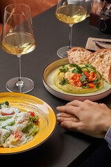 Intimate dining with wine, Caesar salad and hummus with shrimp