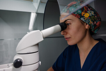 Dedicated real scientist using microscope in lab
