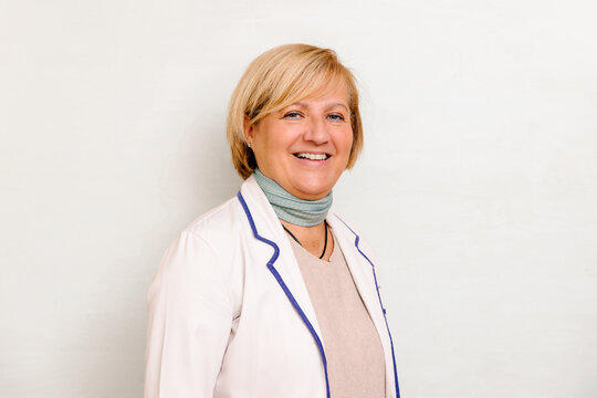 Smiling Mature Female Doctor in White Lab Coat