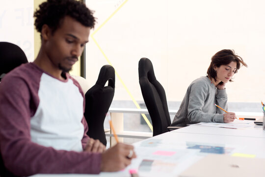 Colleagues Focused on Individual Work in Collaborative Office Space
