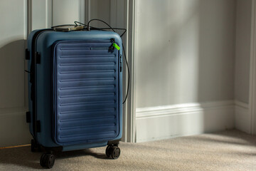 Small wheeled suitcase with a charging port and a mobile phone