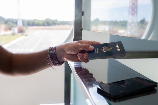 Hand Presenting Passport at Airport Check-In