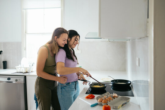 LGBTQ couple cooking in a Queenslander house in Australia