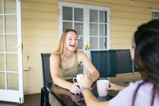 Happy couple enjoying coffee on the deck at home