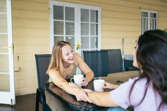 Happy couple having breakfast on the deck at home