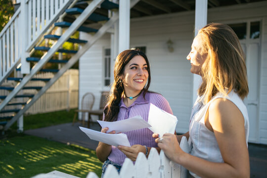 Couple checking the mailbox in a Queenslander house