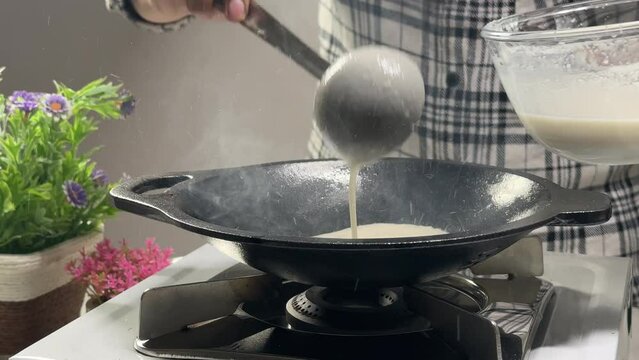 Women making or cooking Appam Palappam Kallappam vella appam made of rice batter plain hoppers