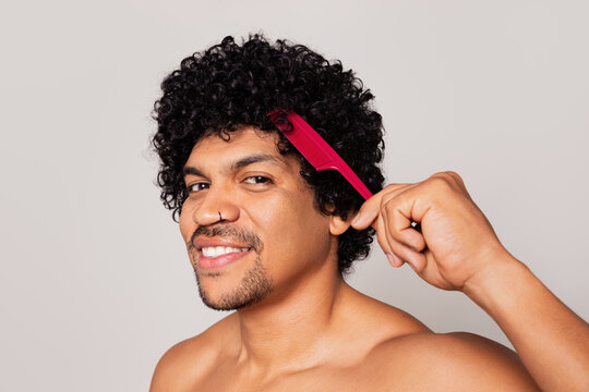 Man combing his curly hair