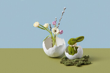 Vases in form of broken egg shell with flower bouquet and green hare