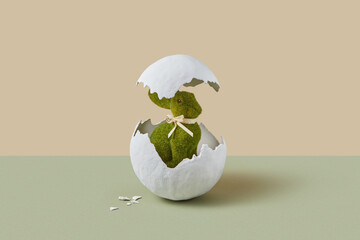 Festive toy in bunny shape hatching from giant egg in studio