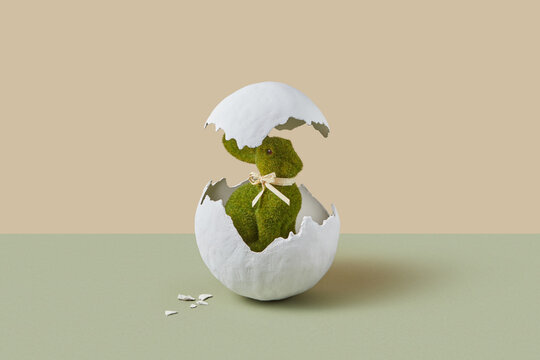 Festive toy in bunny shape hatching from giant egg in studio