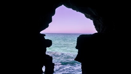 Scenic view of ocean waves seen from a cave