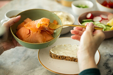 Preparing smoked salmon breakfast toast