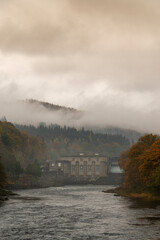 Scenic view of mountain range with mist at sunrise or sunset