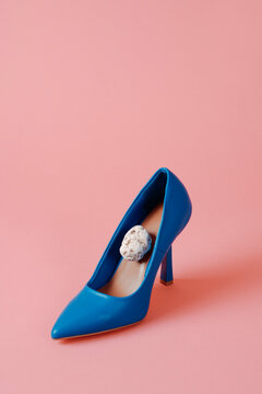 blue high-heeled shoe with a stone